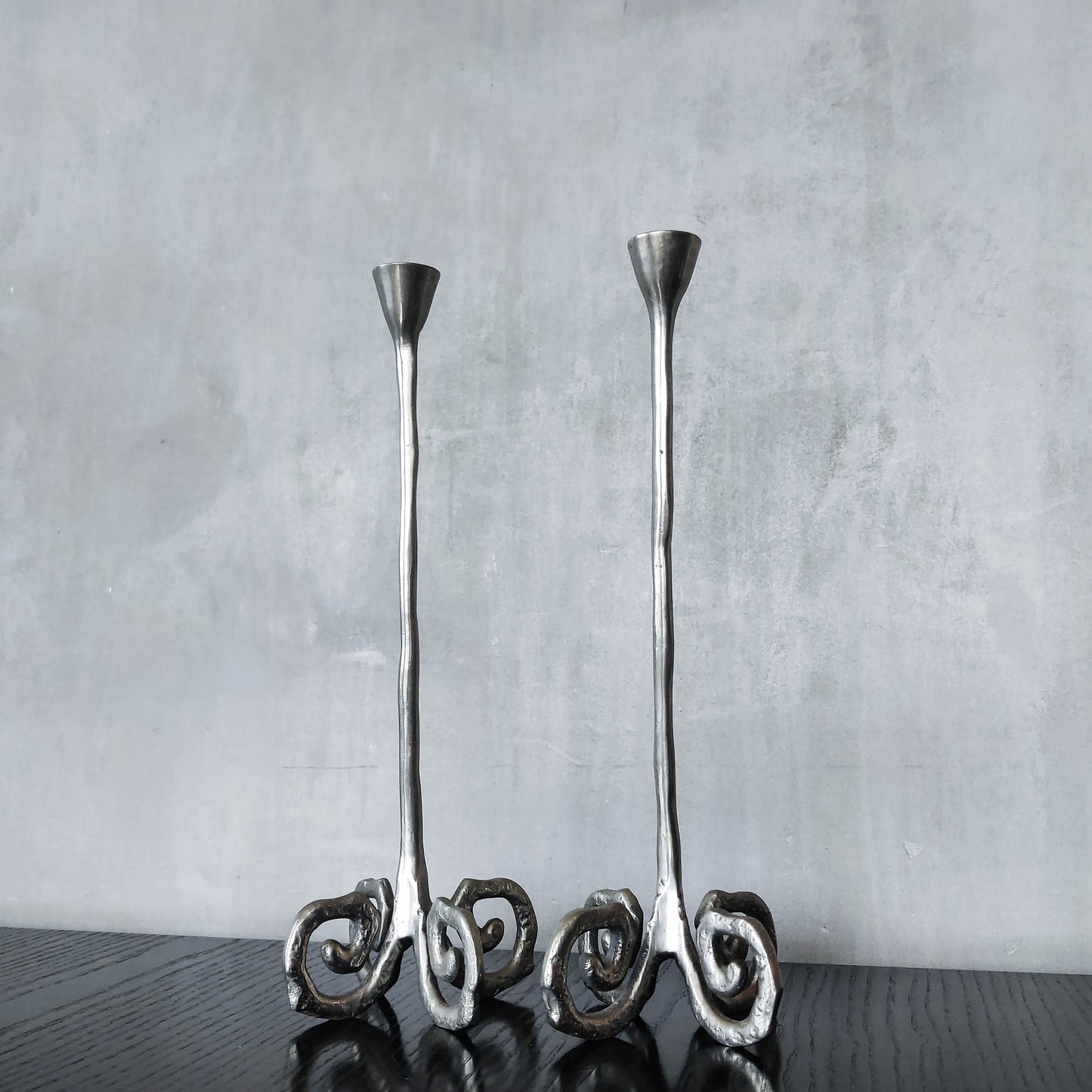 Pair of vintage cast aluminium candle holders with spiral feet