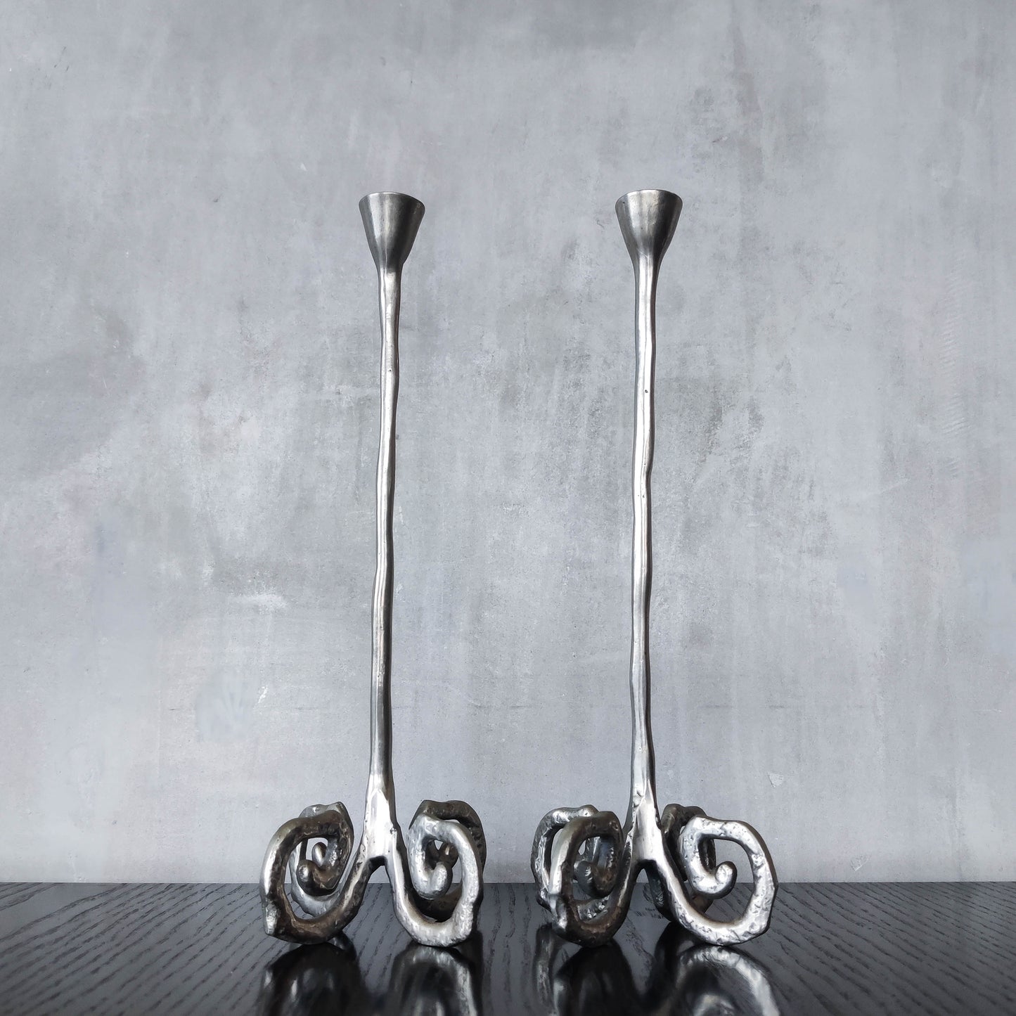 Pair of vintage cast aluminium candle holders with spiral feet