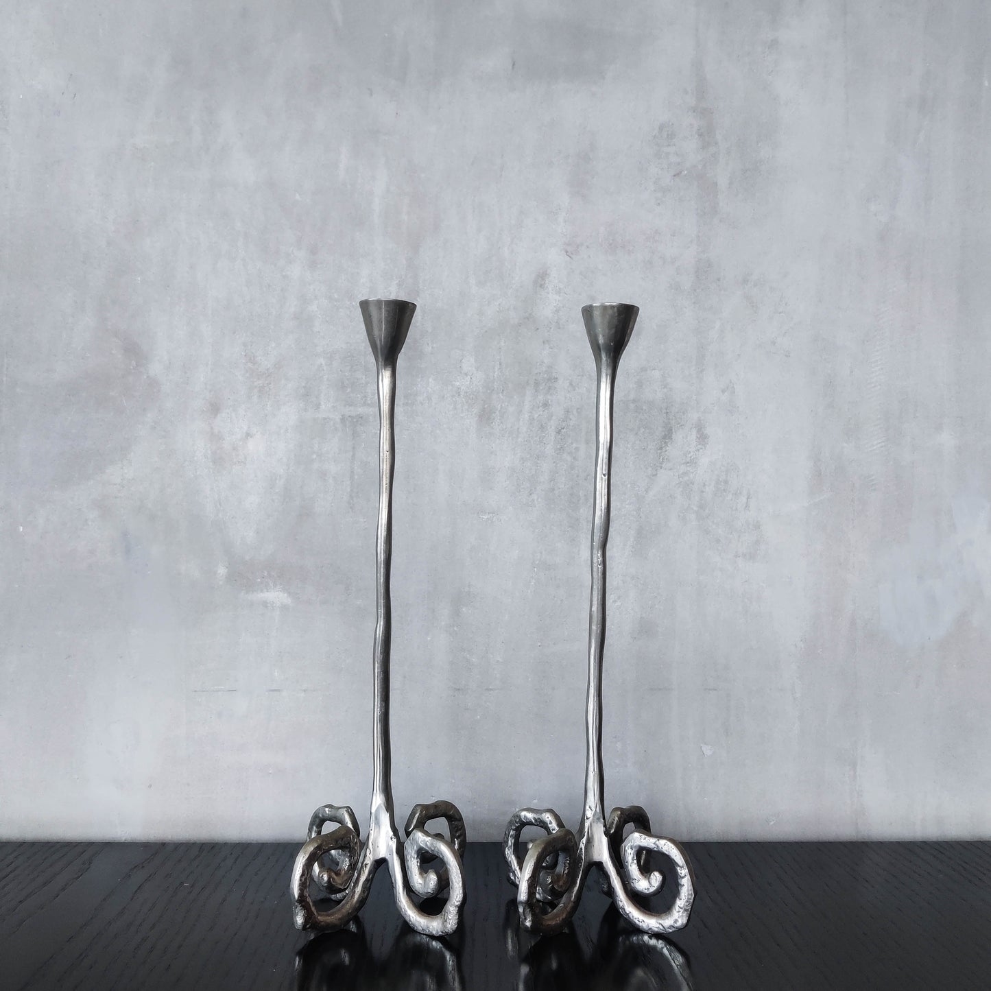 Pair of vintage cast aluminium candle holders with spiral feet