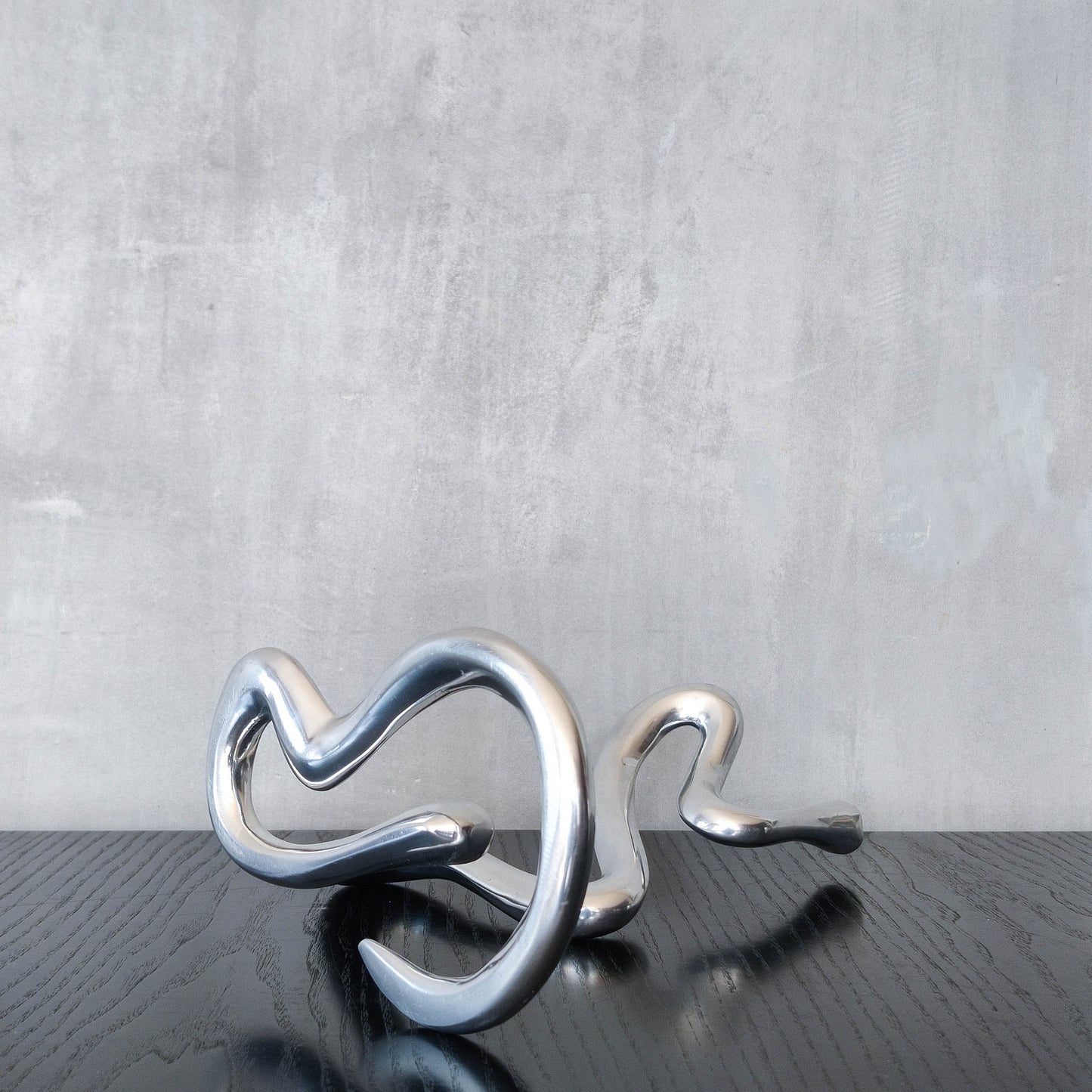 00s cast aluminium sculptural wavy candle holder
