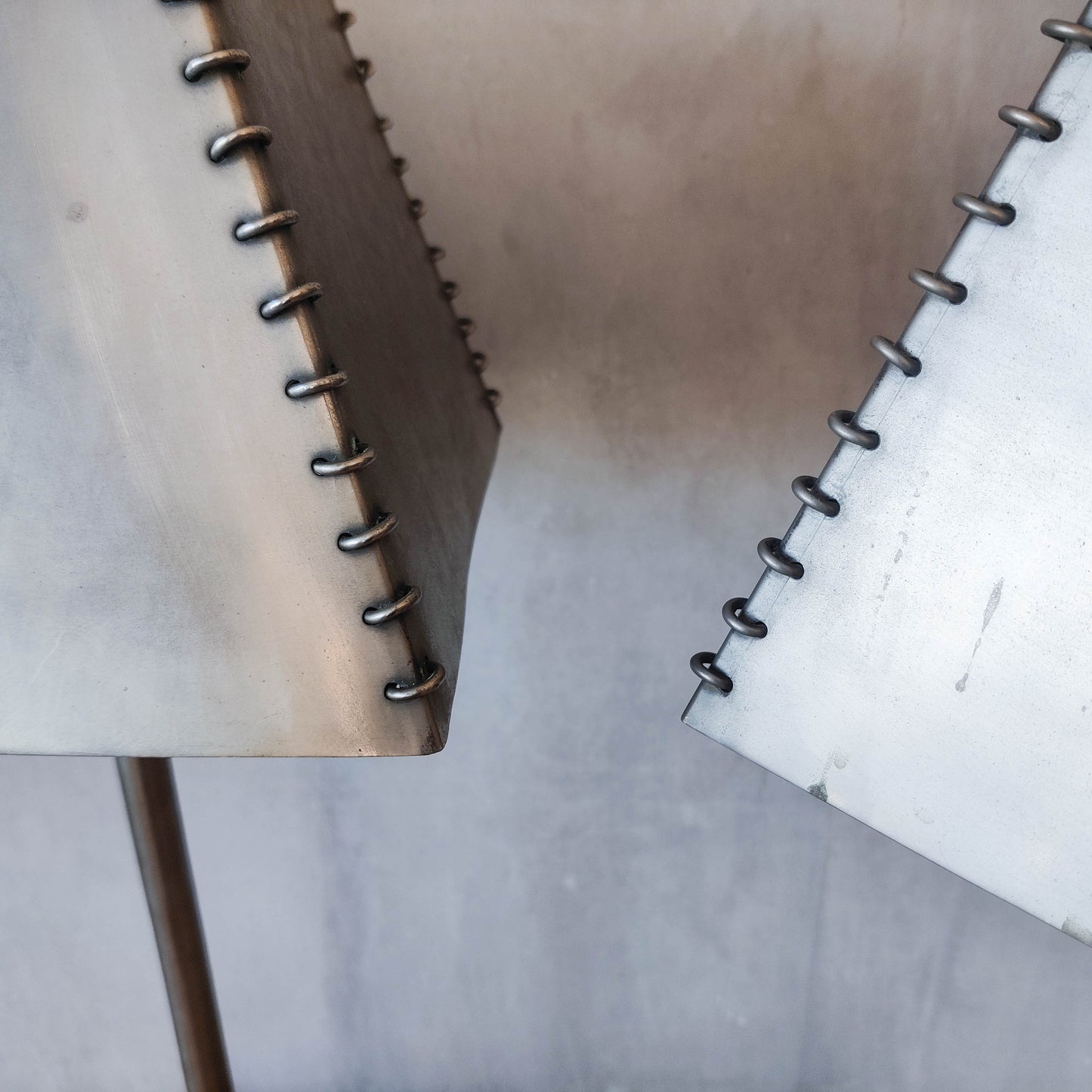 A pair of tall early 1990s Habitat 'Ashrafi' sculptural steel lamps
