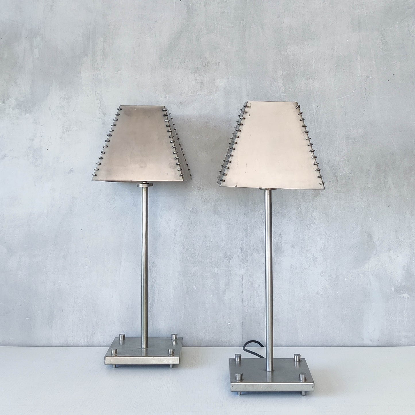 A pair of tall early 1990s Habitat 'Ashrafi' sculptural steel lamps