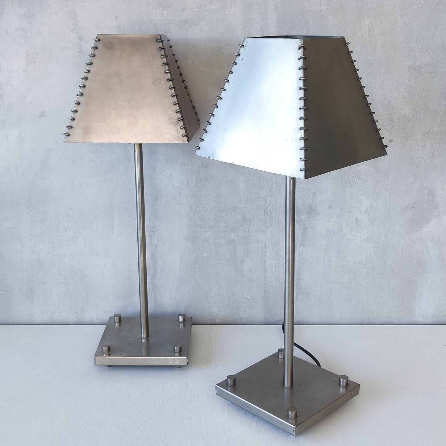 A pair of tall early 1990s Habitat 'Ashrafi' sculptural steel lamps