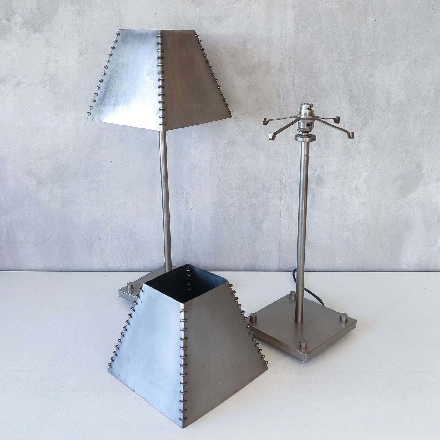 A pair of tall early 1990s Habitat 'Ashrafi' sculptural steel lamps