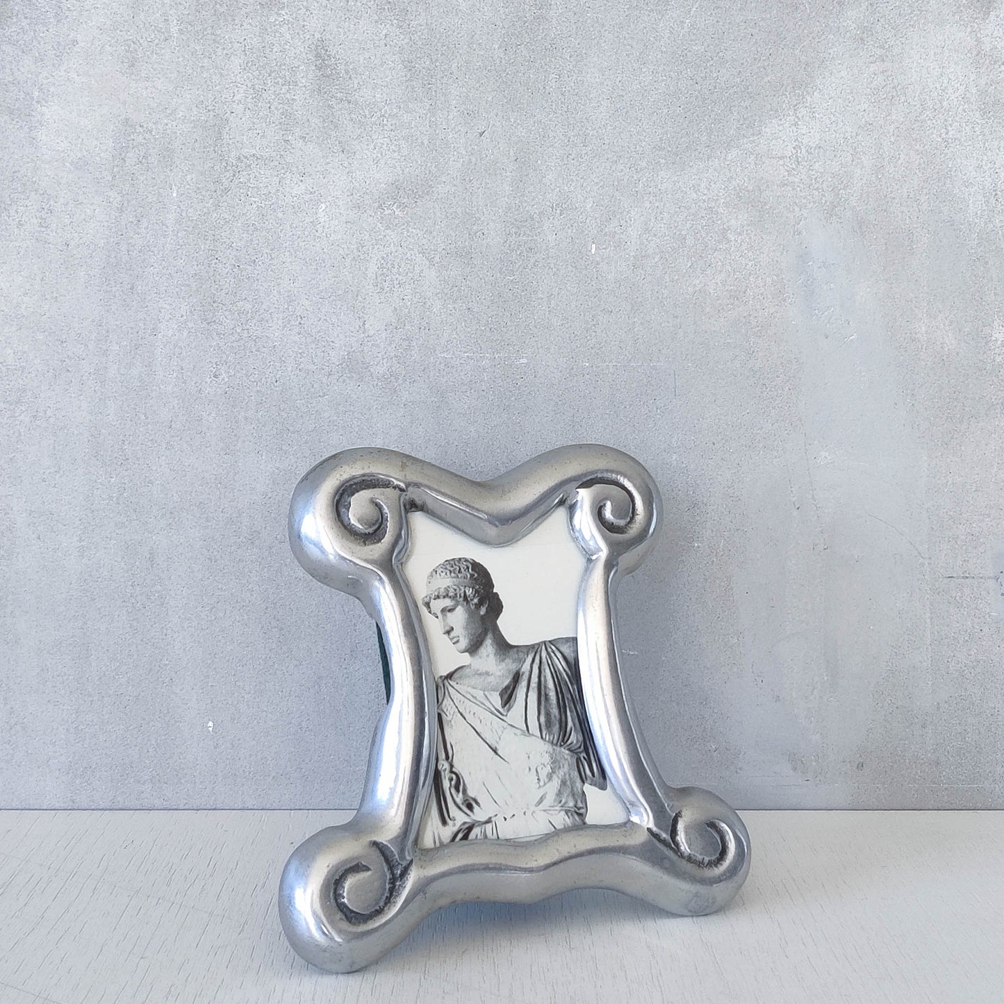 A 1990s cast aluminium chunky frame with inscribed spirals