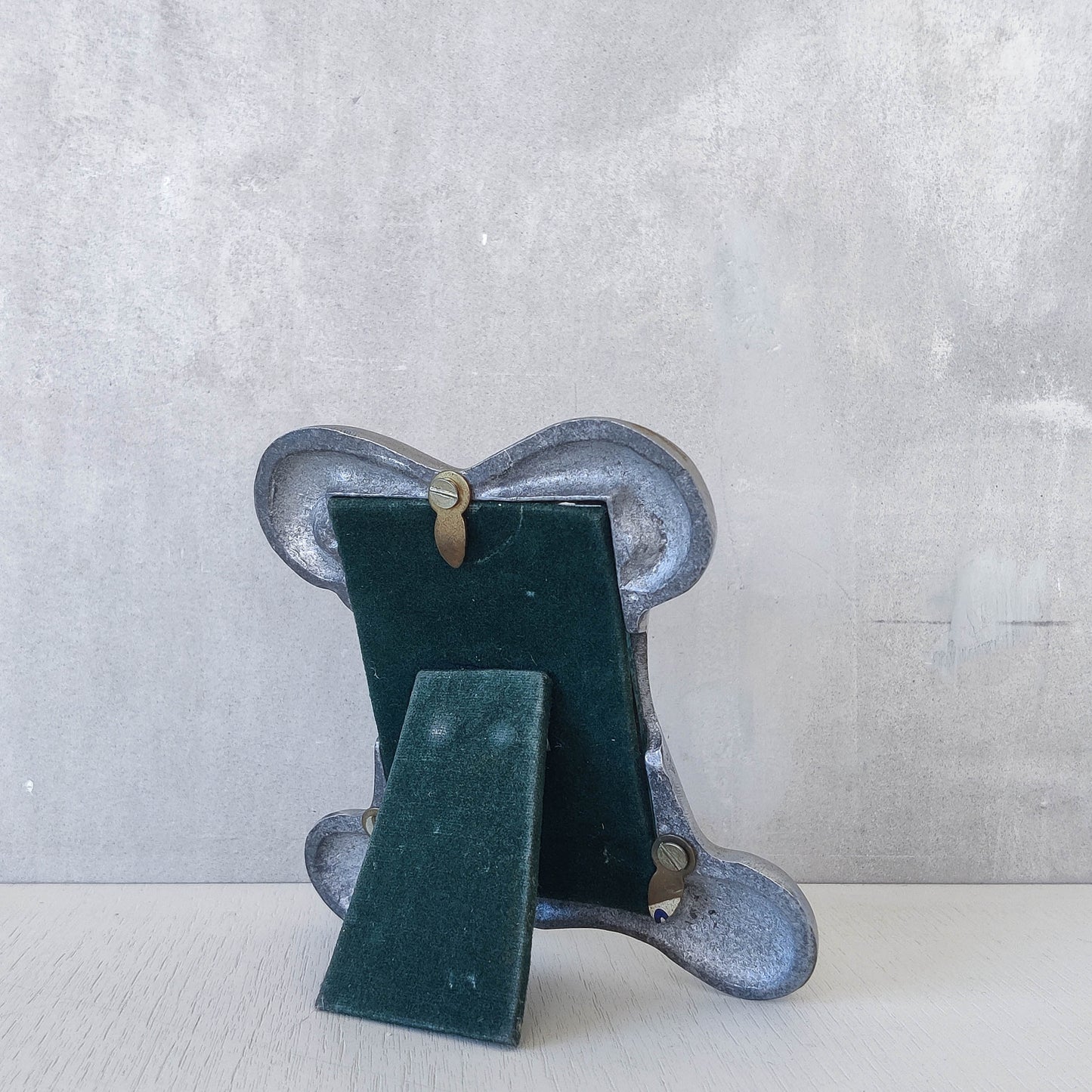 A 1990s cast aluminium chunky frame with inscribed spirals