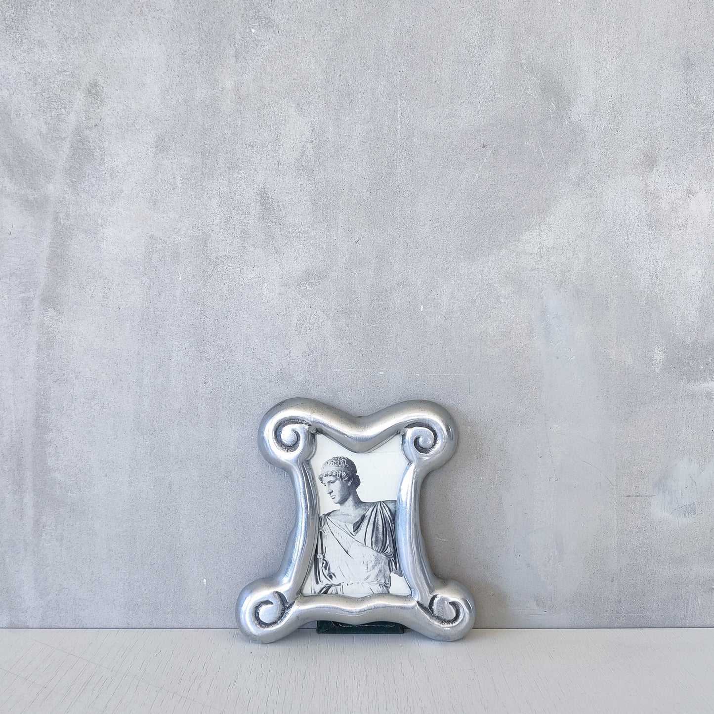 A 1990s cast aluminium chunky frame with inscribed spirals