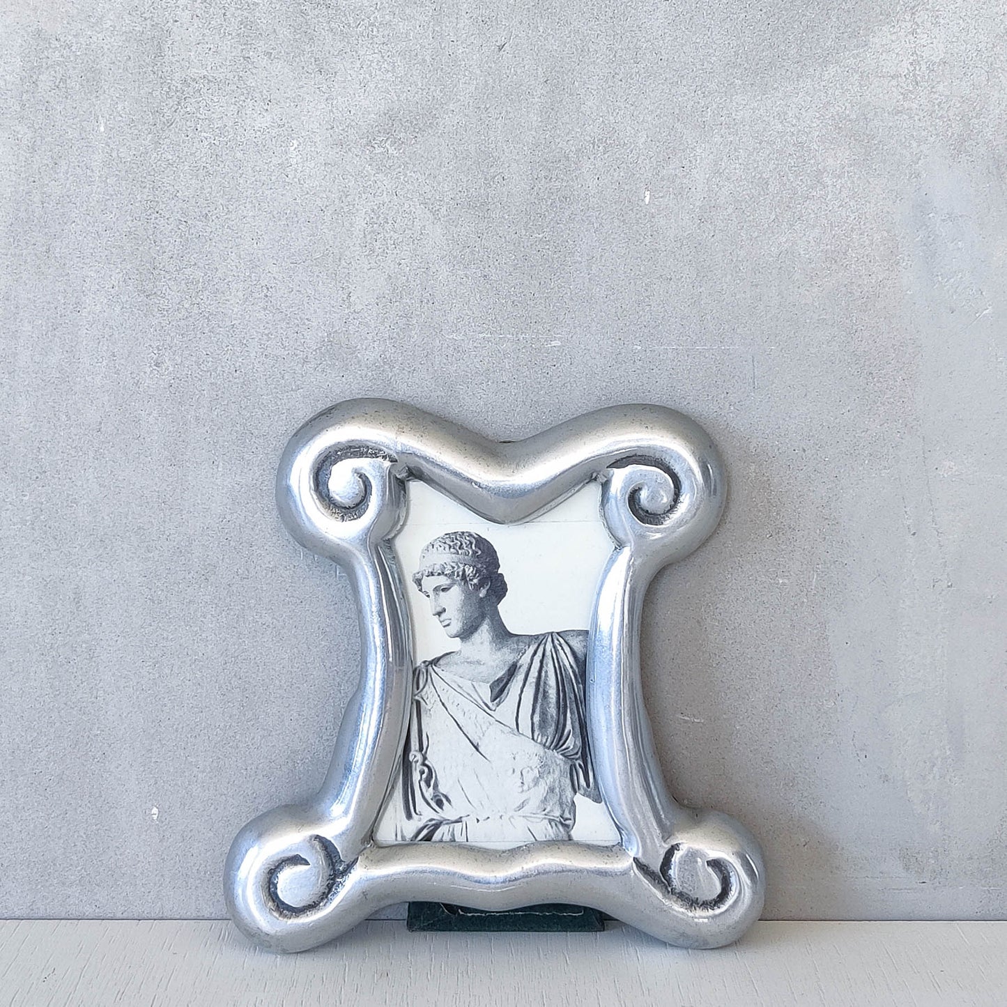 A 1990s cast aluminium chunky frame with inscribed spirals