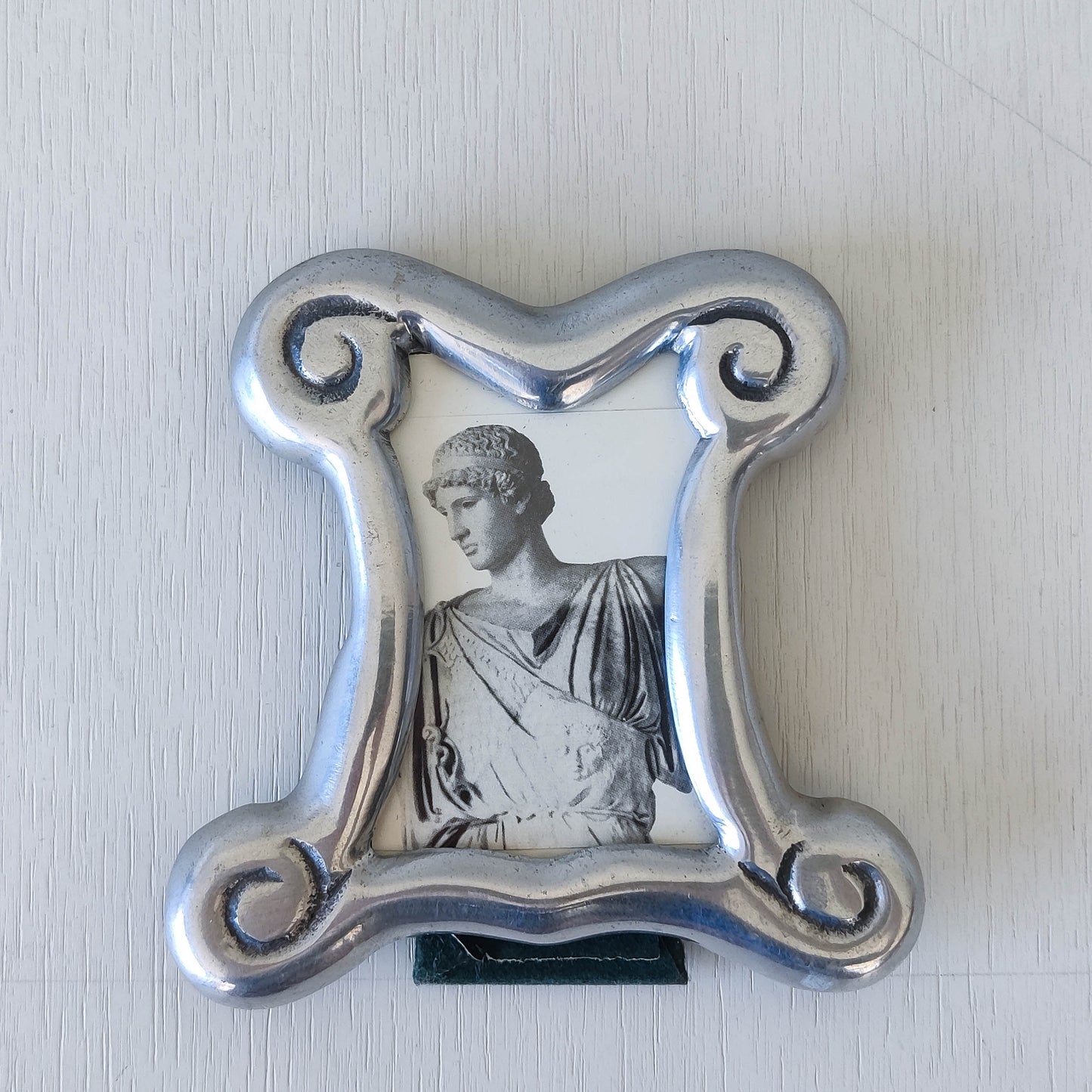 A 1990s cast aluminium chunky frame with inscribed spirals
