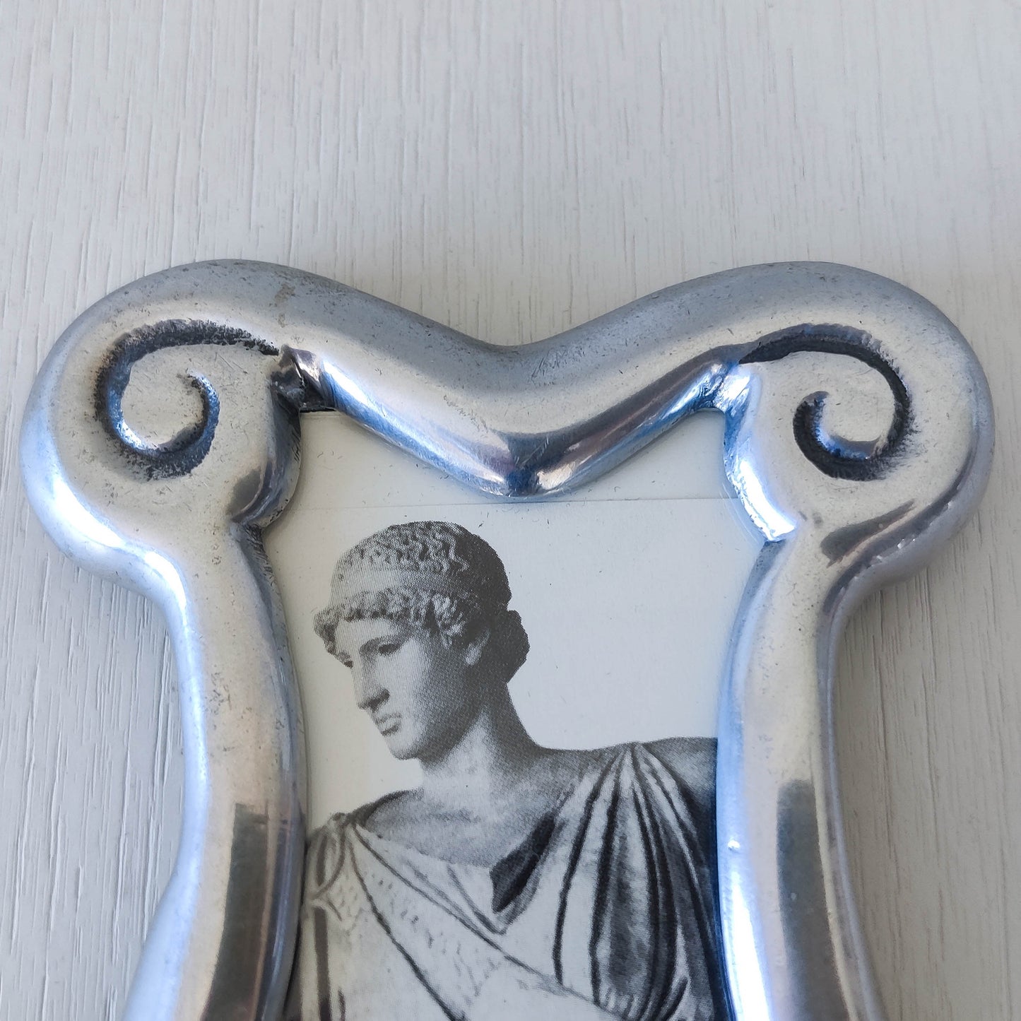 A 1990s cast aluminium chunky frame with inscribed spirals