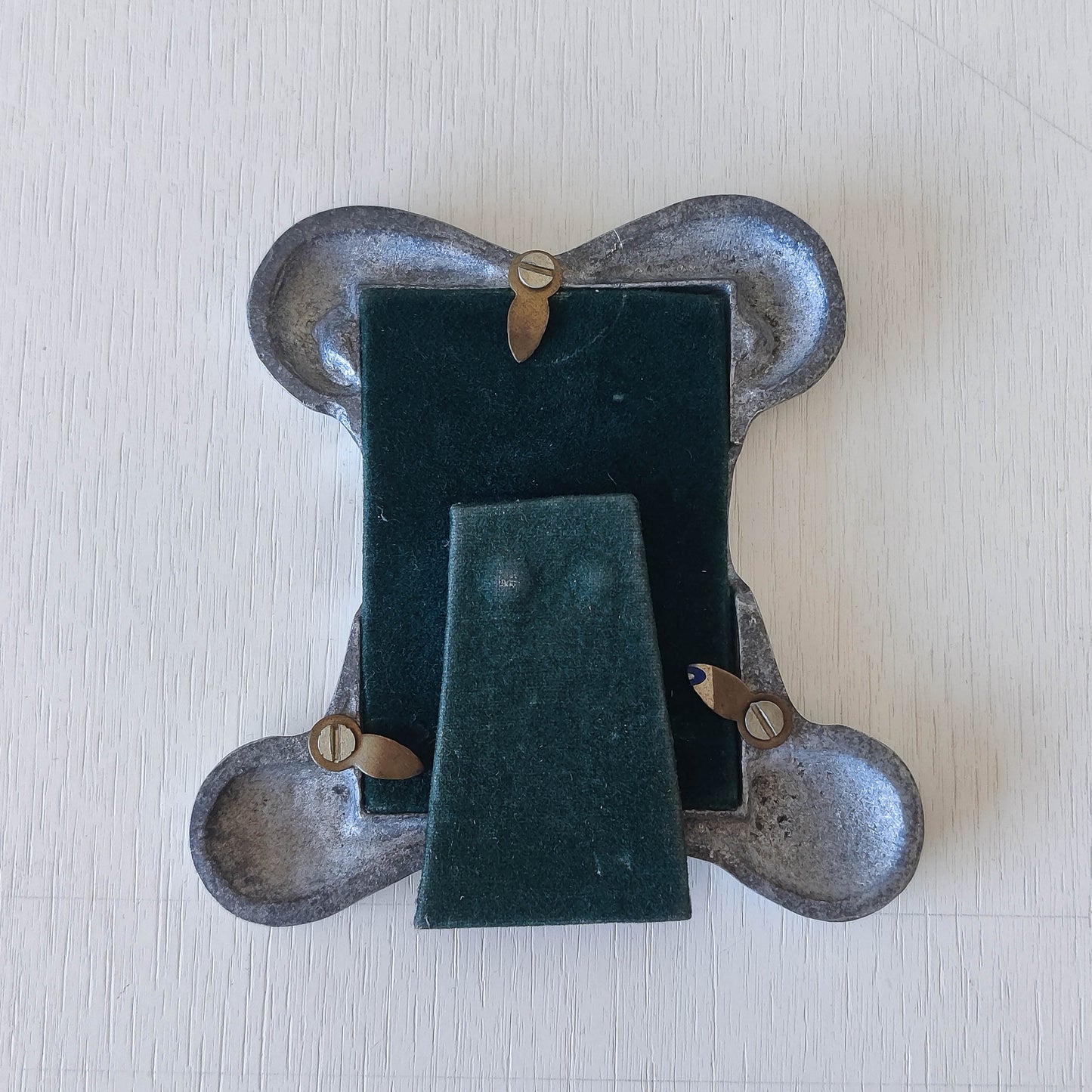 A 1990s cast aluminium chunky frame with inscribed spirals