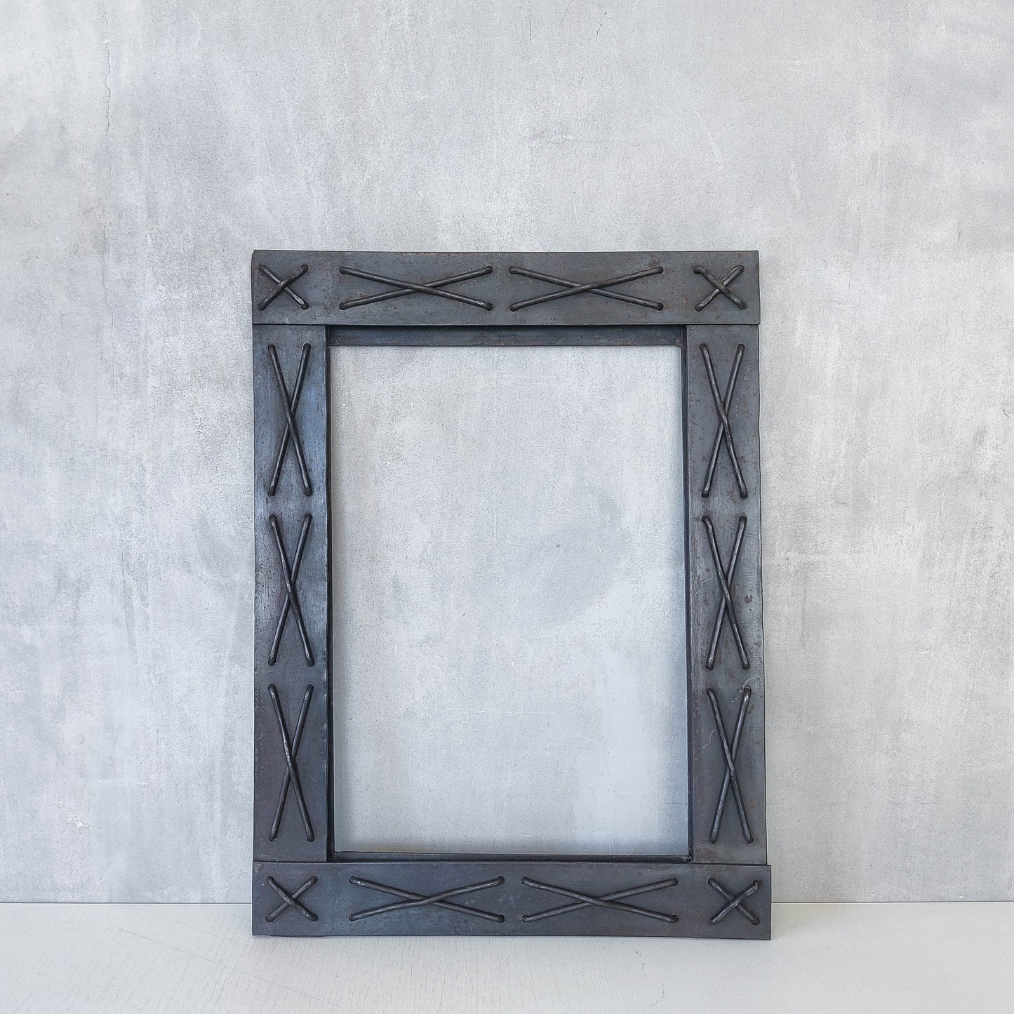 Handmade metalwork welded steel frame with laced cross details