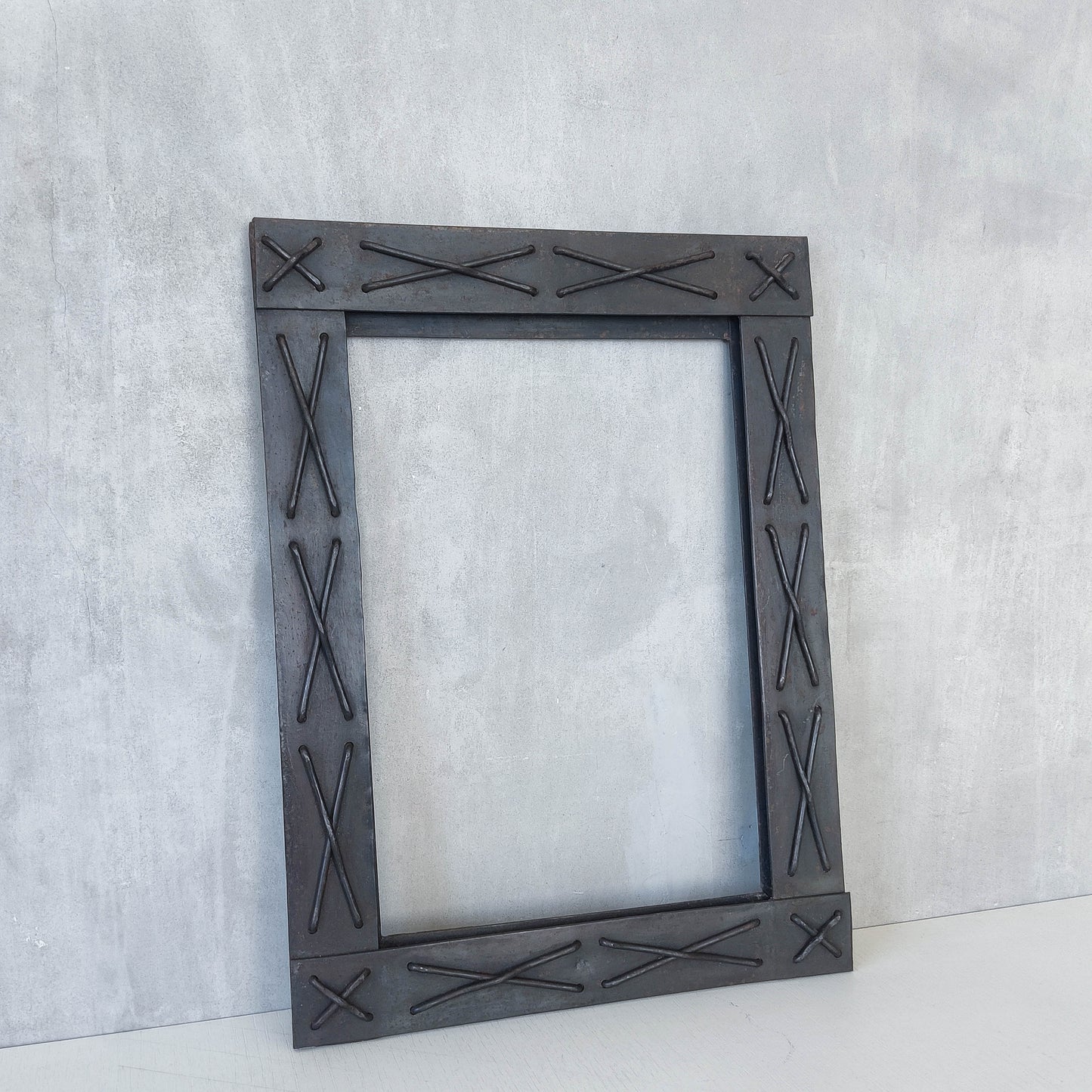 Handmade metalwork welded steel frame with laced cross details