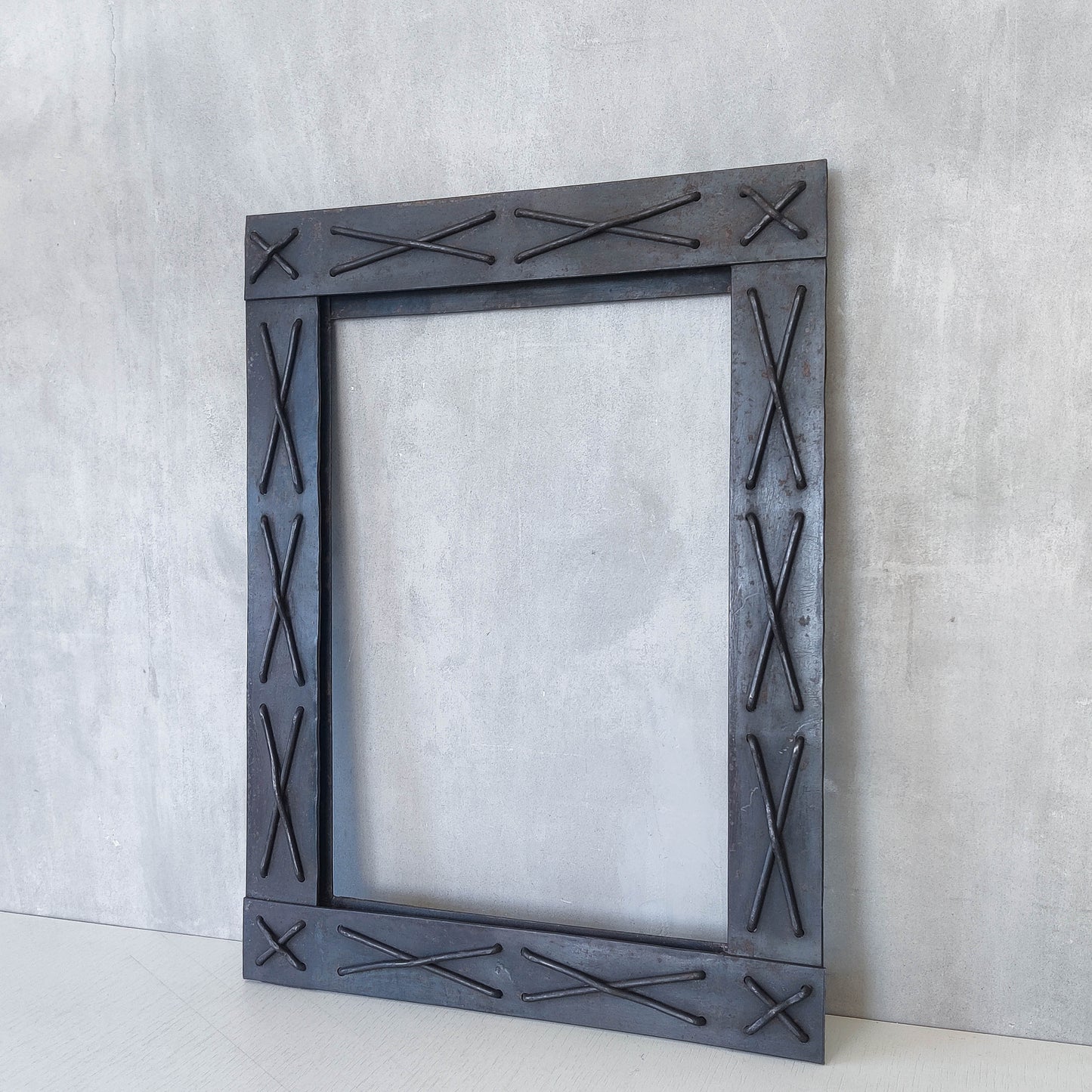 Handmade metalwork welded steel frame with laced cross details