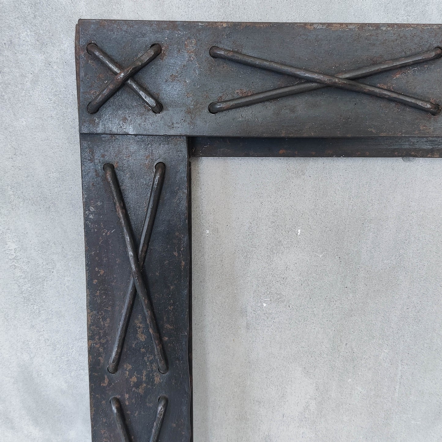 Handmade metalwork welded steel frame with laced cross details