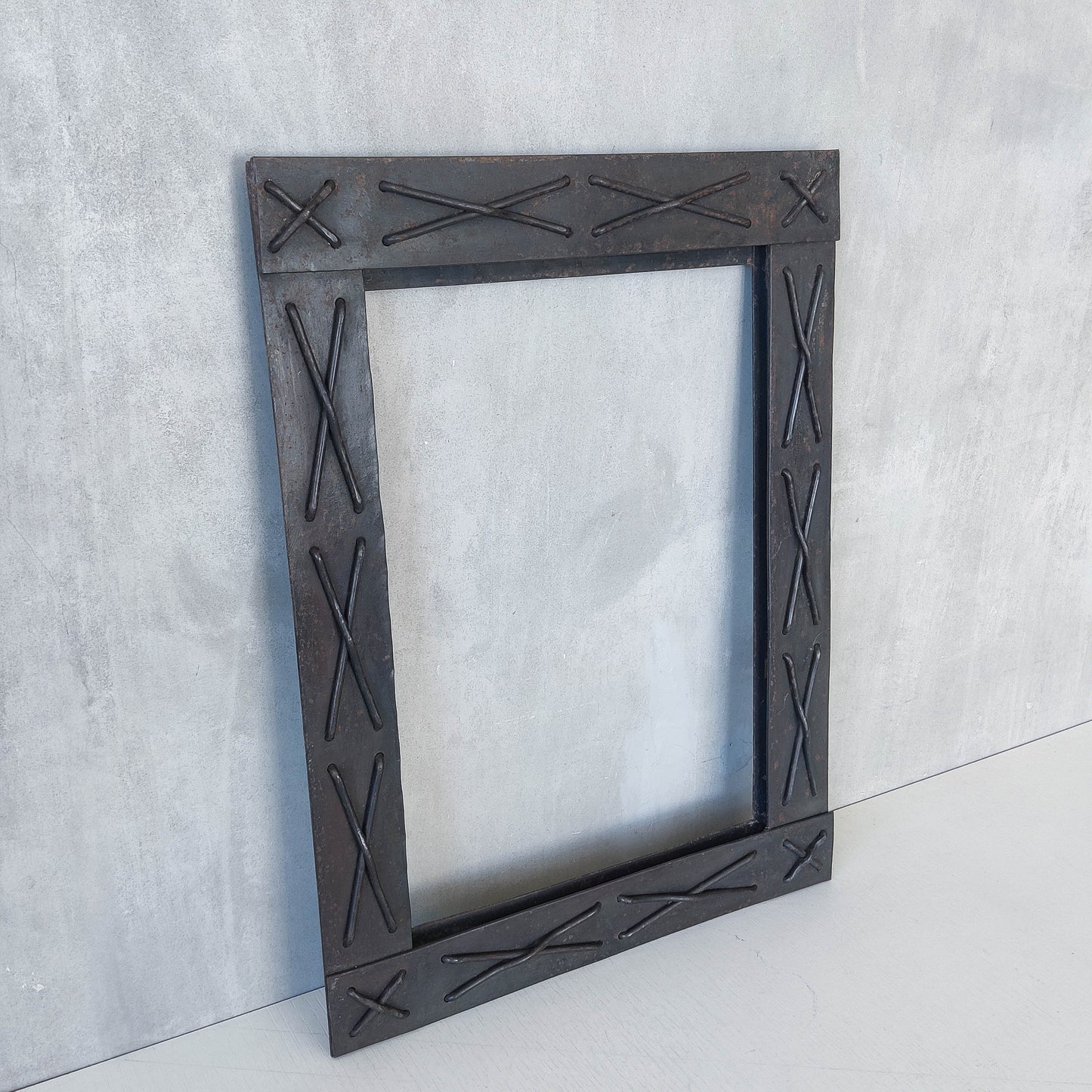 Handmade metalwork welded steel frame with laced cross details