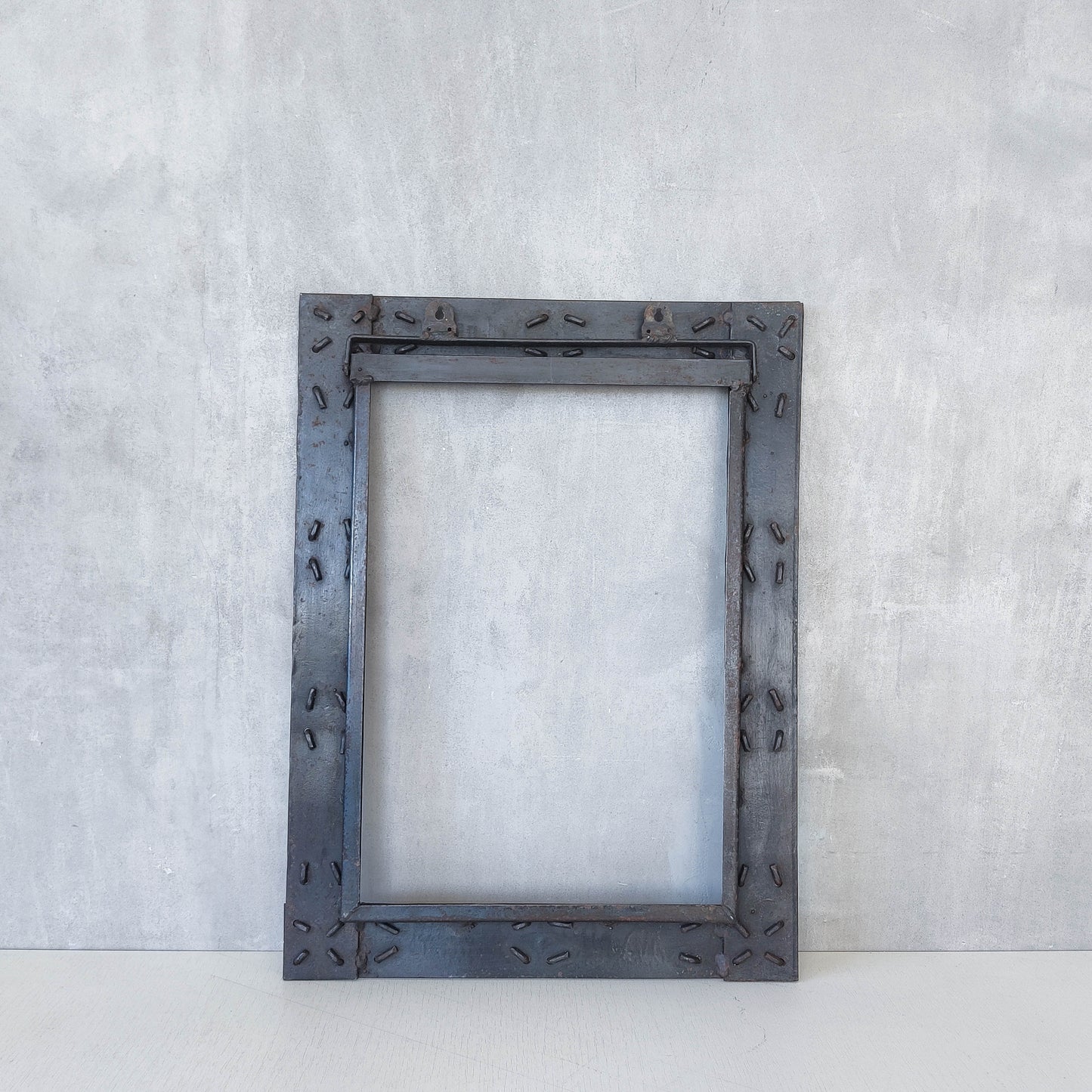 Handmade metalwork welded steel frame with laced cross details