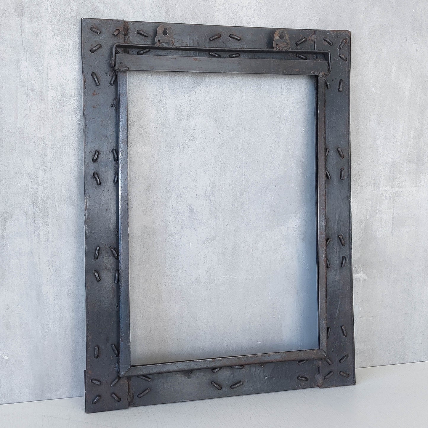 Handmade metalwork welded steel frame with laced cross details