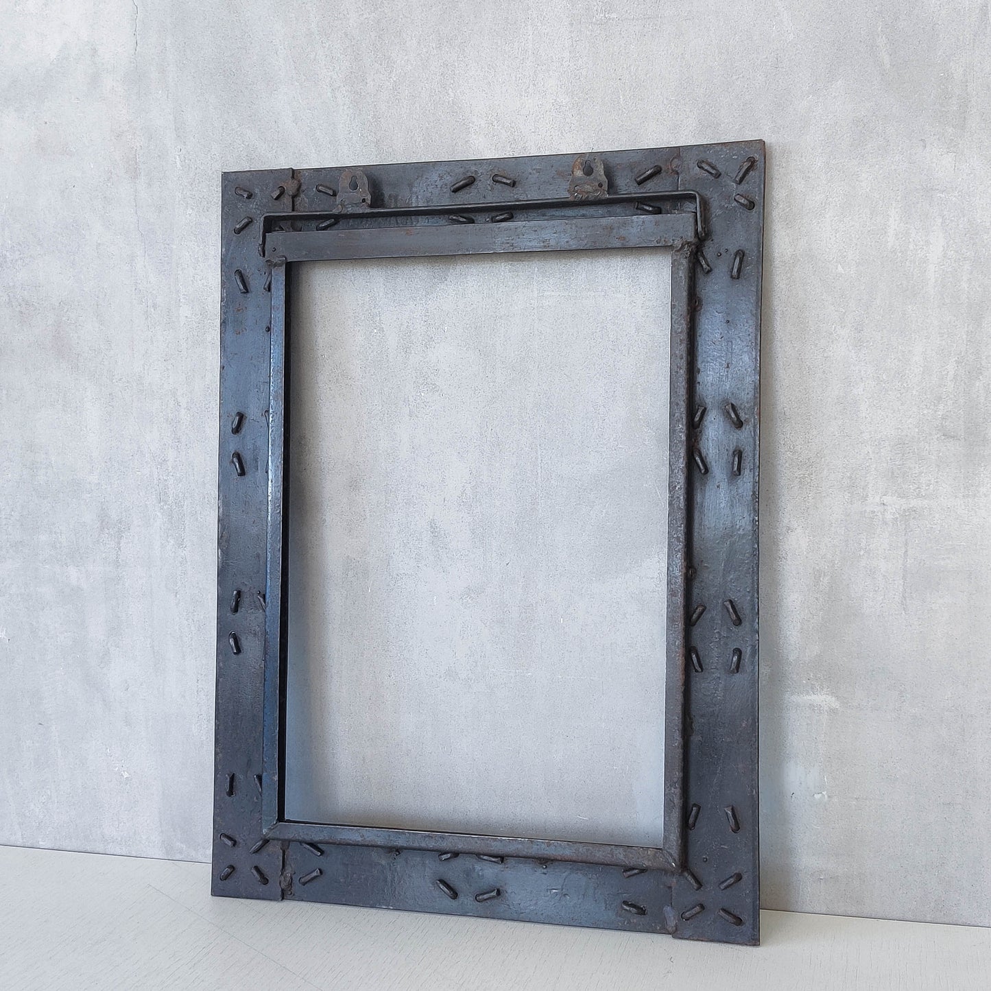 Handmade metalwork welded steel frame with laced cross details