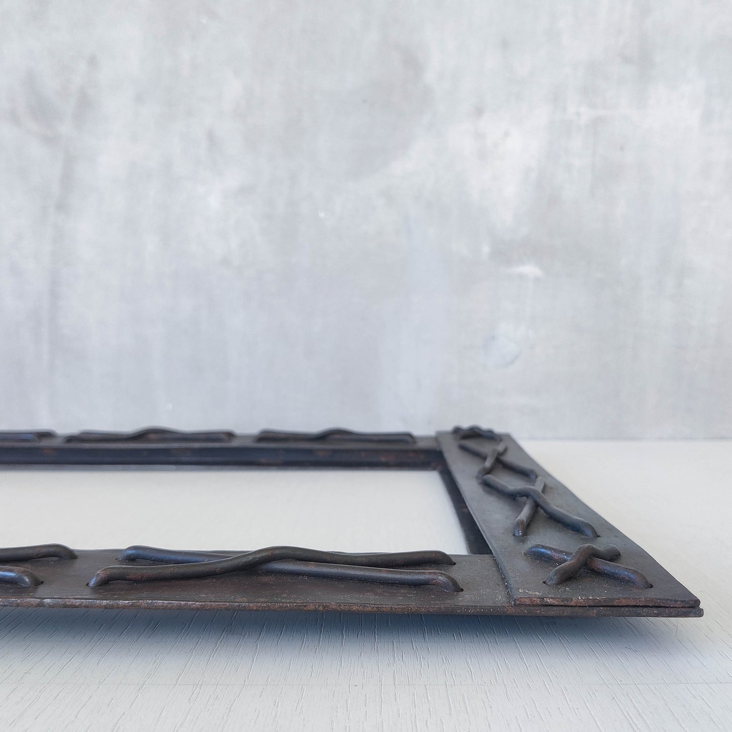 Handmade metalwork welded steel frame with laced cross details
