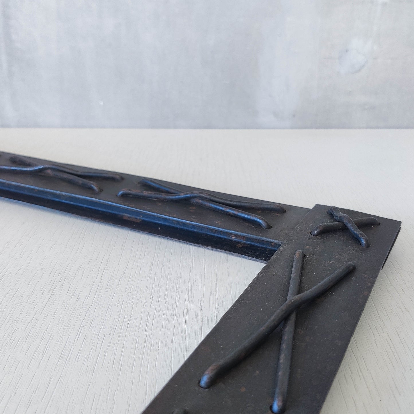 Handmade metalwork welded steel frame with laced cross details