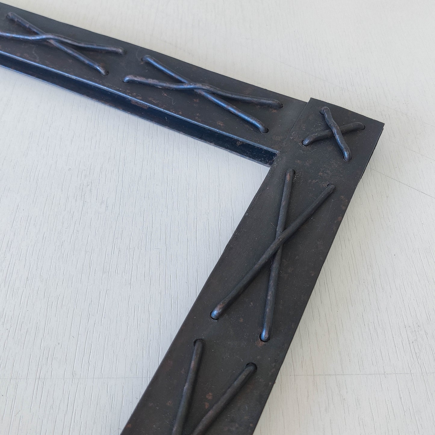 Handmade metalwork welded steel frame with laced cross details