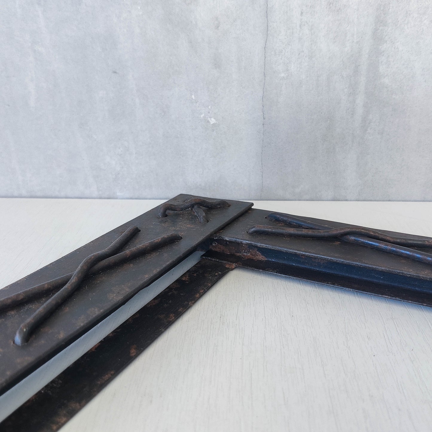 Handmade metalwork welded steel frame with laced cross details