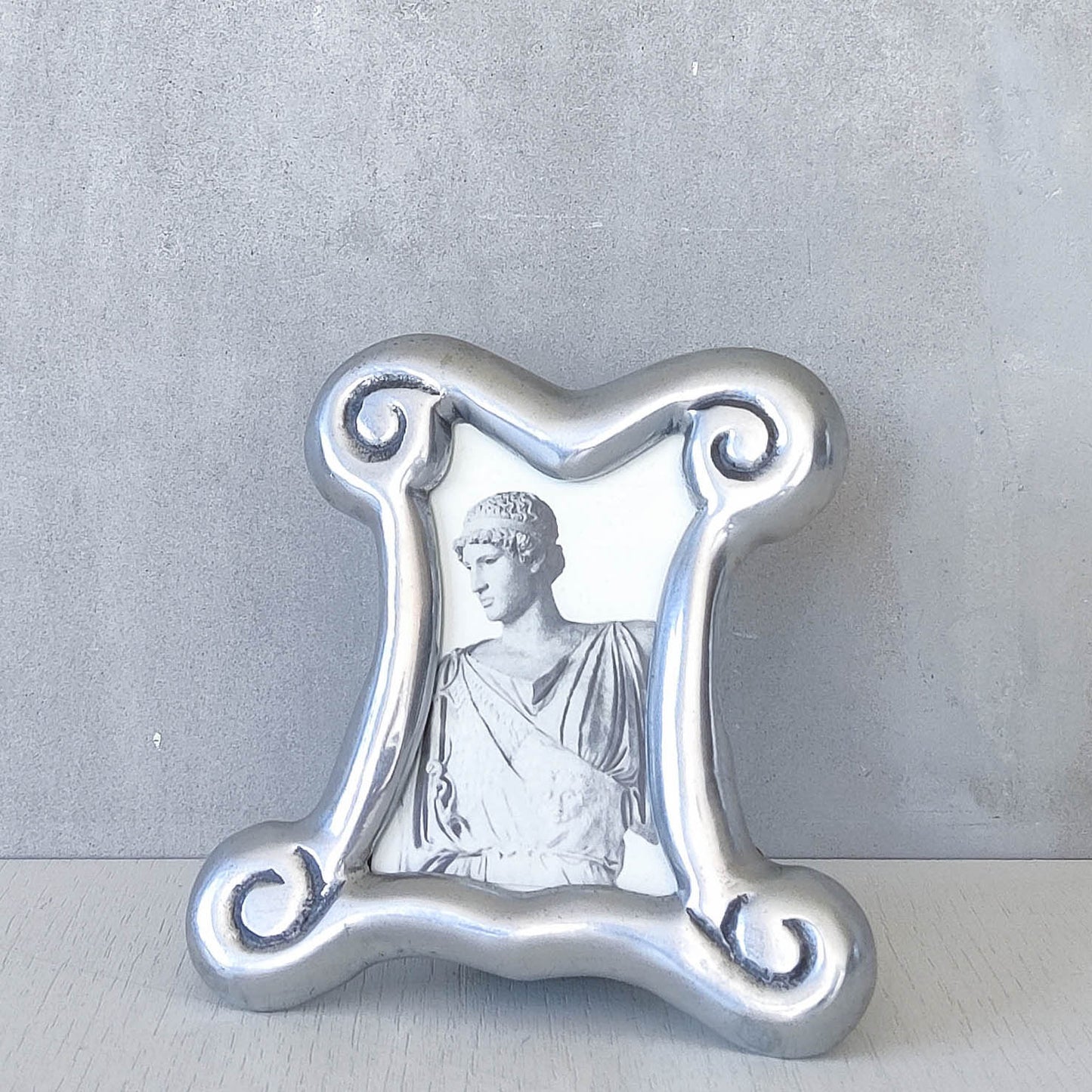 A 1990s cast aluminium chunky frame with inscribed spirals