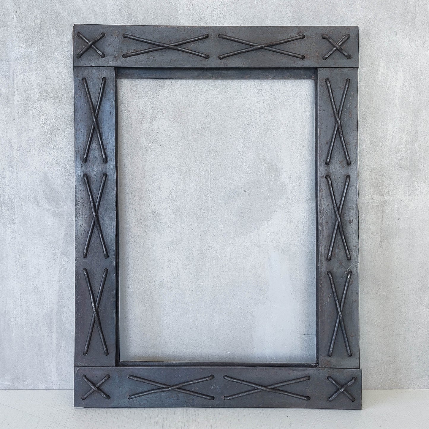 Handmade metalwork welded steel frame with laced cross details