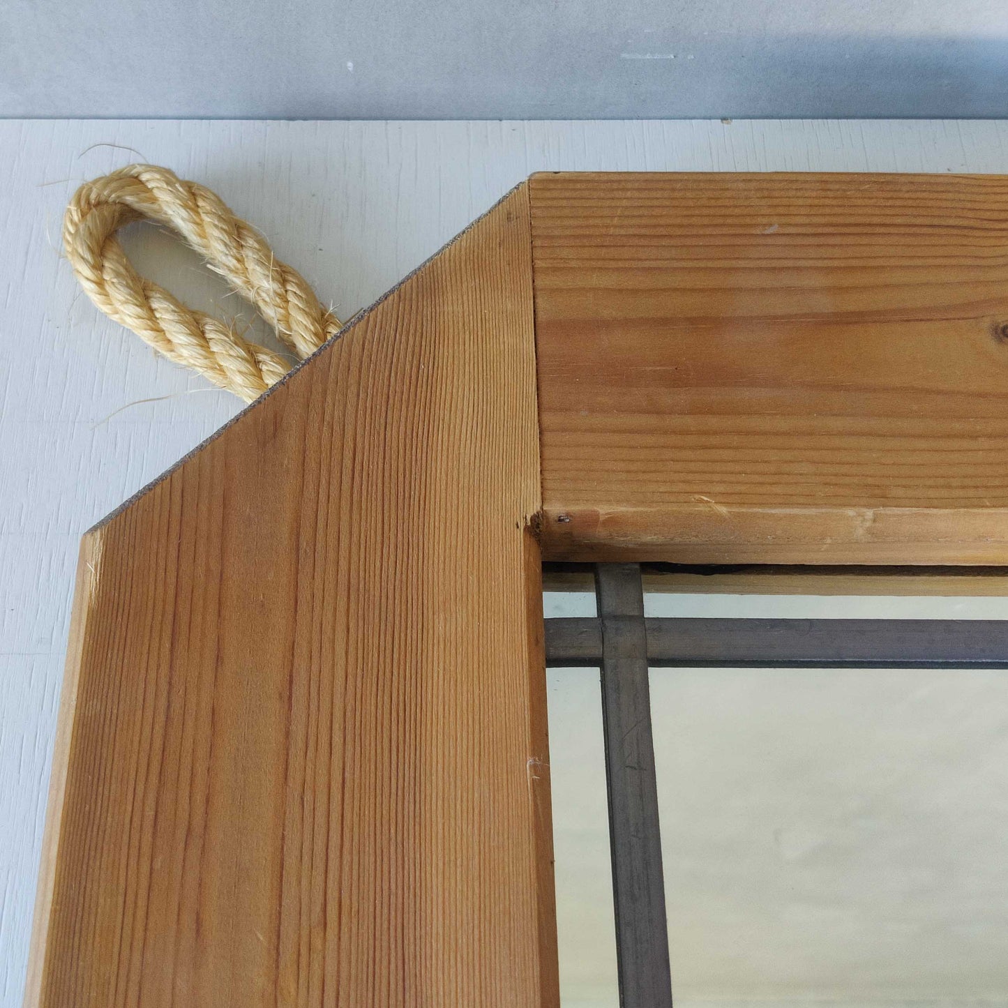 A 1990s pine framed leaded mirror with rope loop