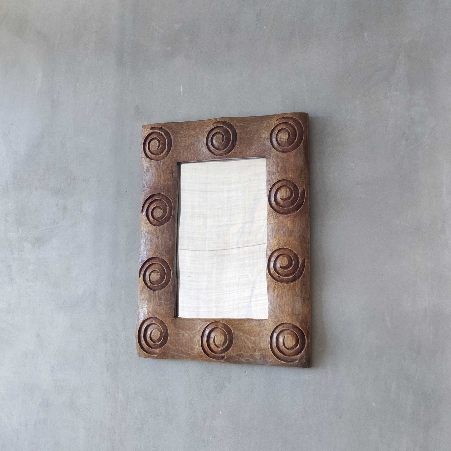 A vintage chunky solid hand carved hardwood wood spiral swirl sculptural mirror