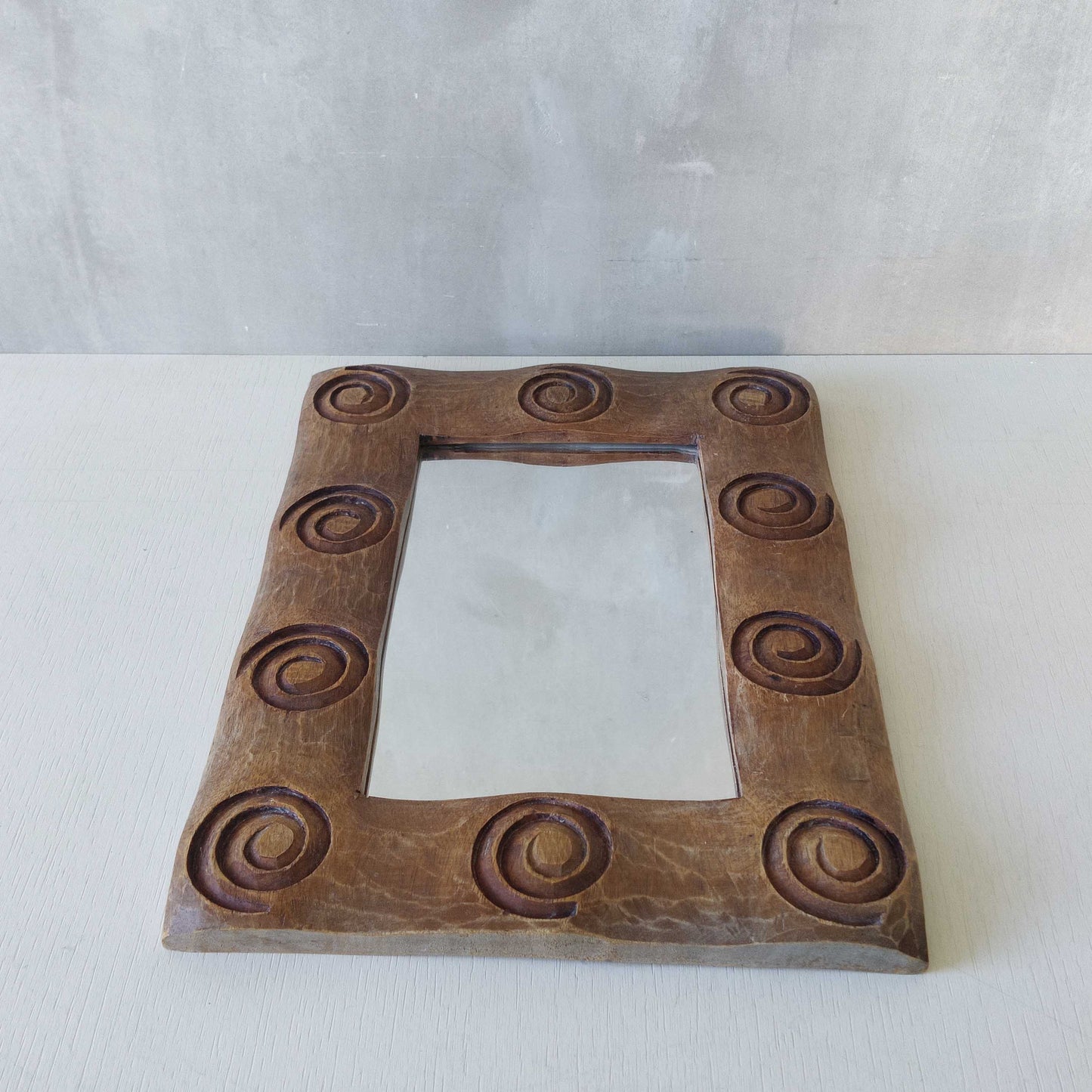 A vintage chunky solid hand carved hardwood wood spiral swirl sculptural mirror