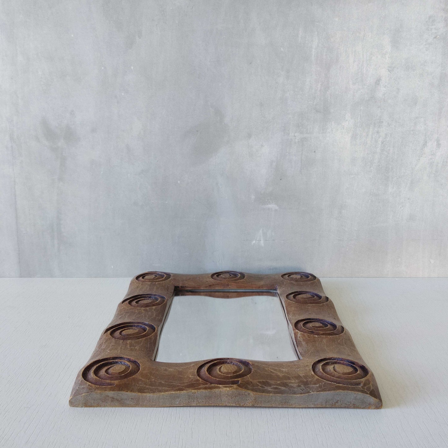 A vintage chunky solid hand carved hardwood wood spiral swirl sculptural mirror