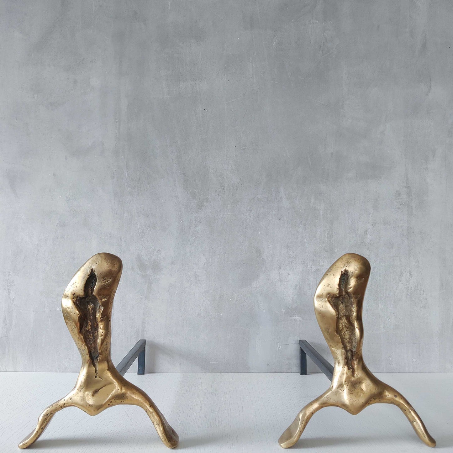 A David Marshall pair of organic brutalist sand cast brass sculptural fire dogs