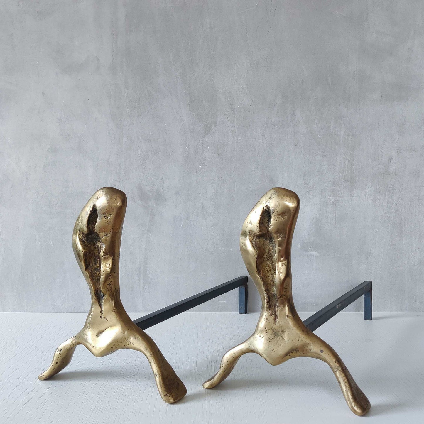 A David Marshall pair of organic brutalist sand cast brass sculptural fire dogs
