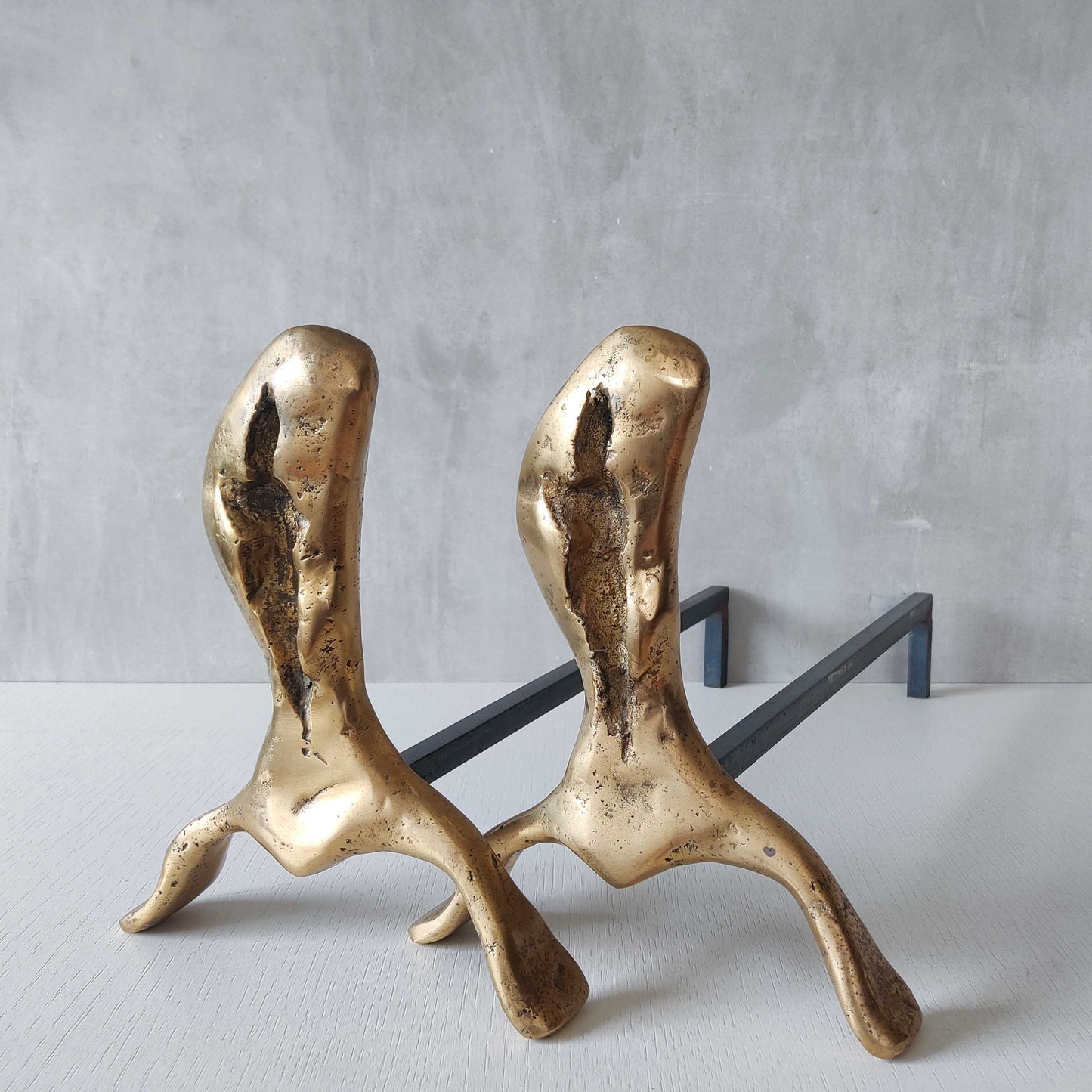A David Marshall pair of organic brutalist sand cast brass sculptural fire dogs