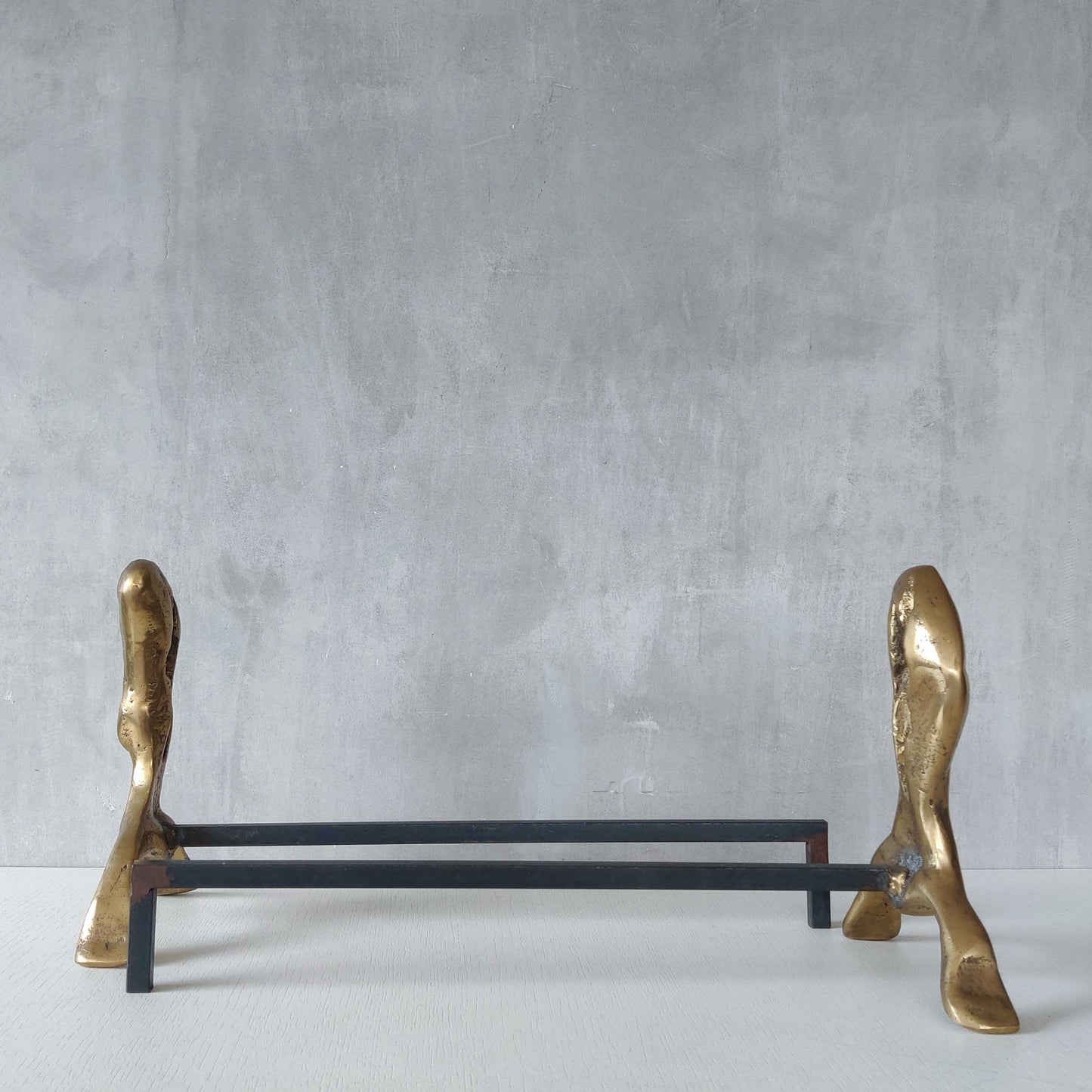 A David Marshall pair of organic brutalist sand cast brass sculptural fire dogs