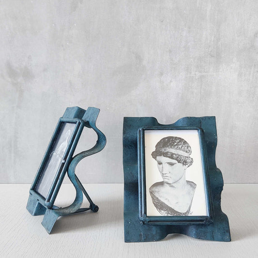 A pair of 1990s sculptural painted handmade metalwork wavy photo frames