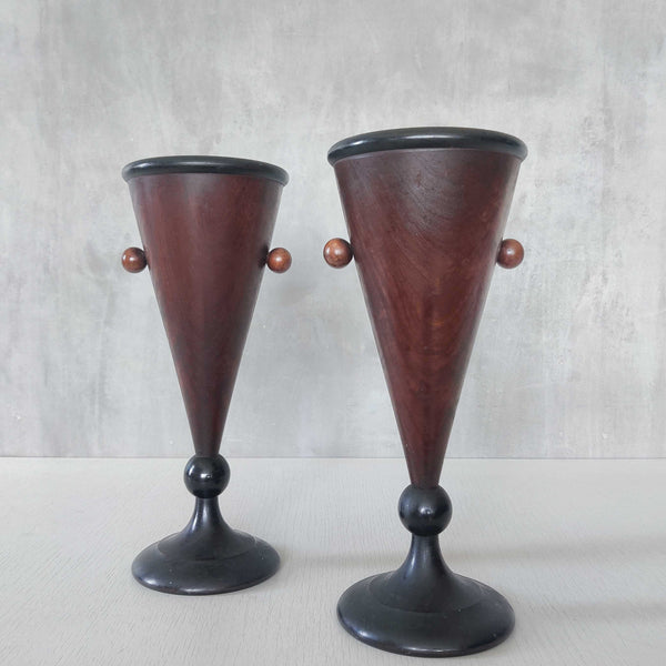 A pair of Art Deco turned walnut conical vessels with ebonised trim