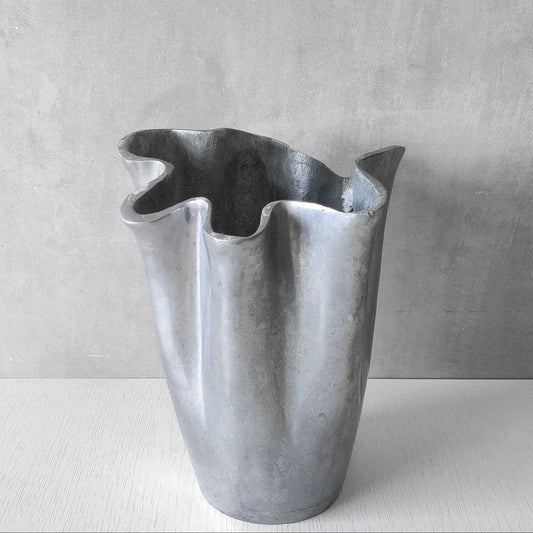 A vintage sculptural draped fluted cast aluminium handkerchief vase