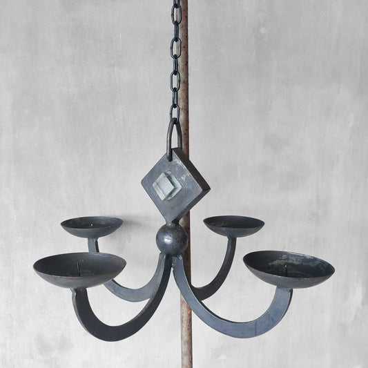A vintage wrought iron hanging candelabra with pressed glass block insert
