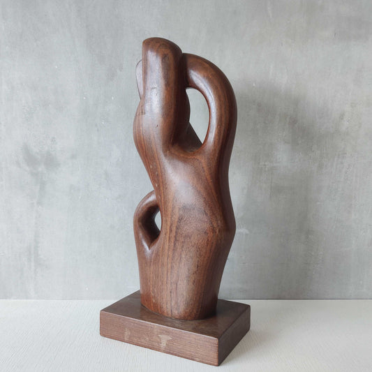 A mid-century hand carved hardwood biomorphic abstract sculpture