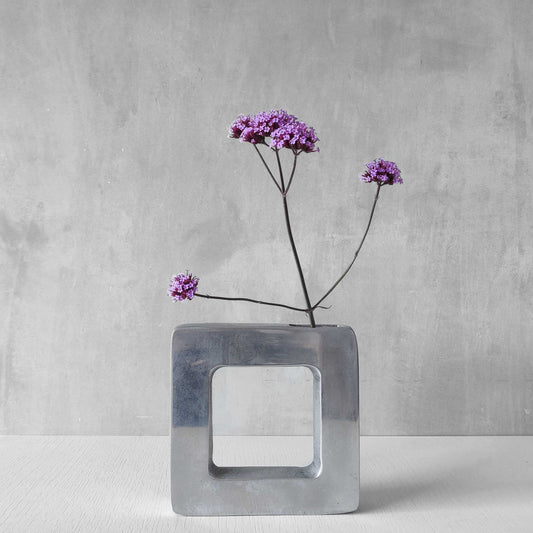 A 1990s cast aluminium geometric doughnut vase