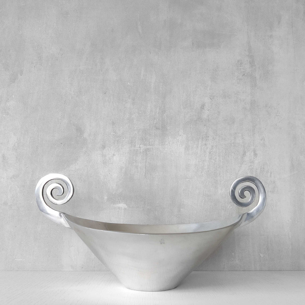 A 1990s cast aluminium centrepiece bowl with spiral handles