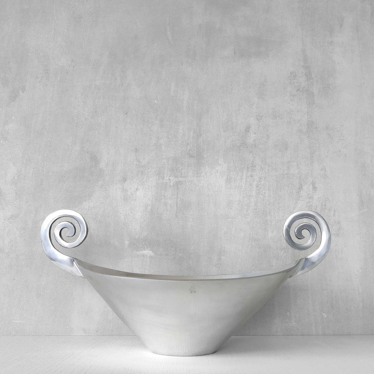 A 1990s cast aluminium centrepiece bowl with spiral handles