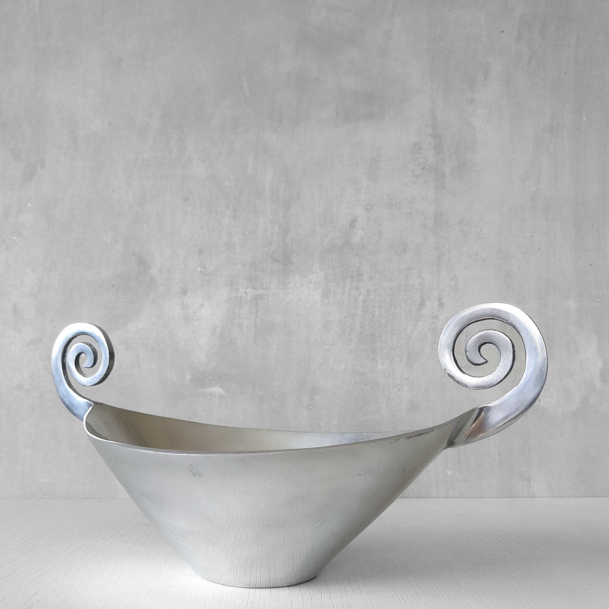 A 1990s cast aluminium centrepiece bowl with spiral handles