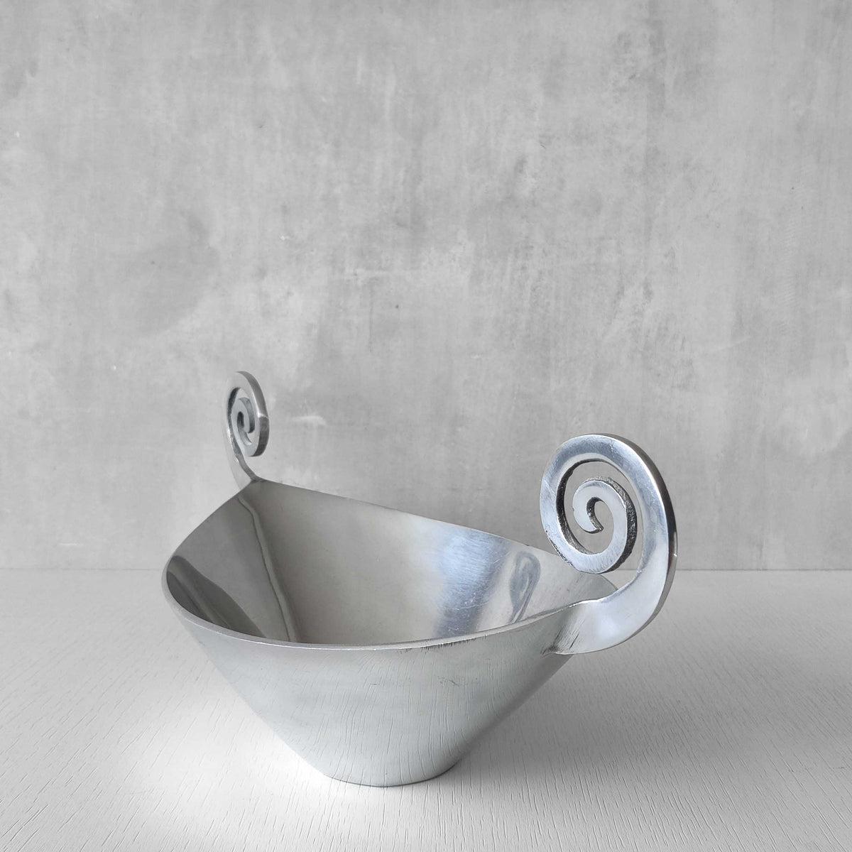 A 1990s cast aluminium centrepiece bowl with spiral handles