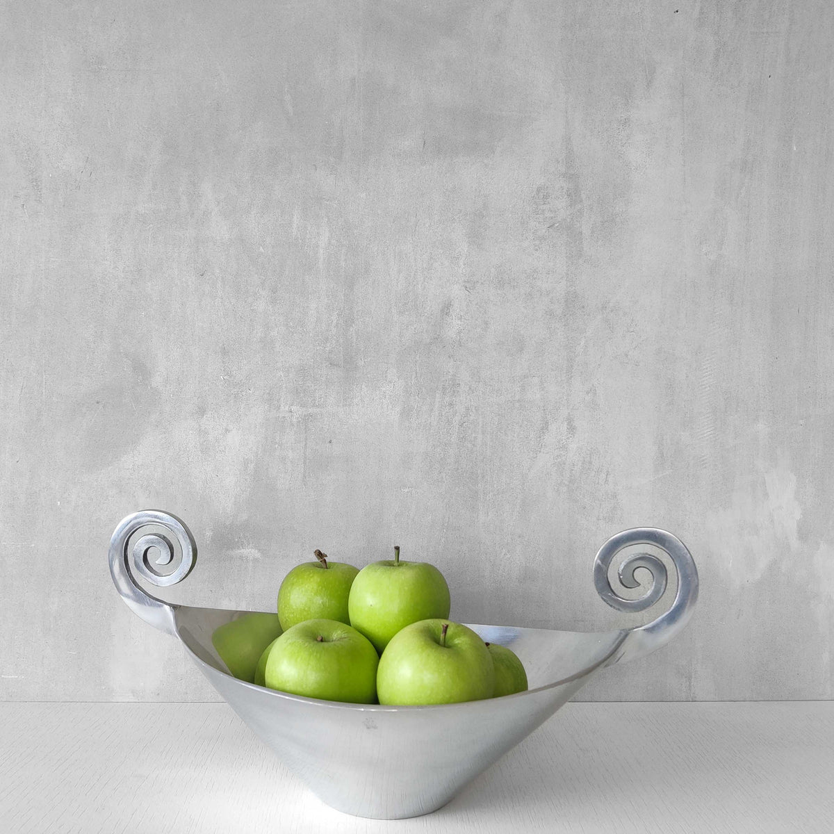 A 1990s cast aluminium centrepiece bowl with spiral handles