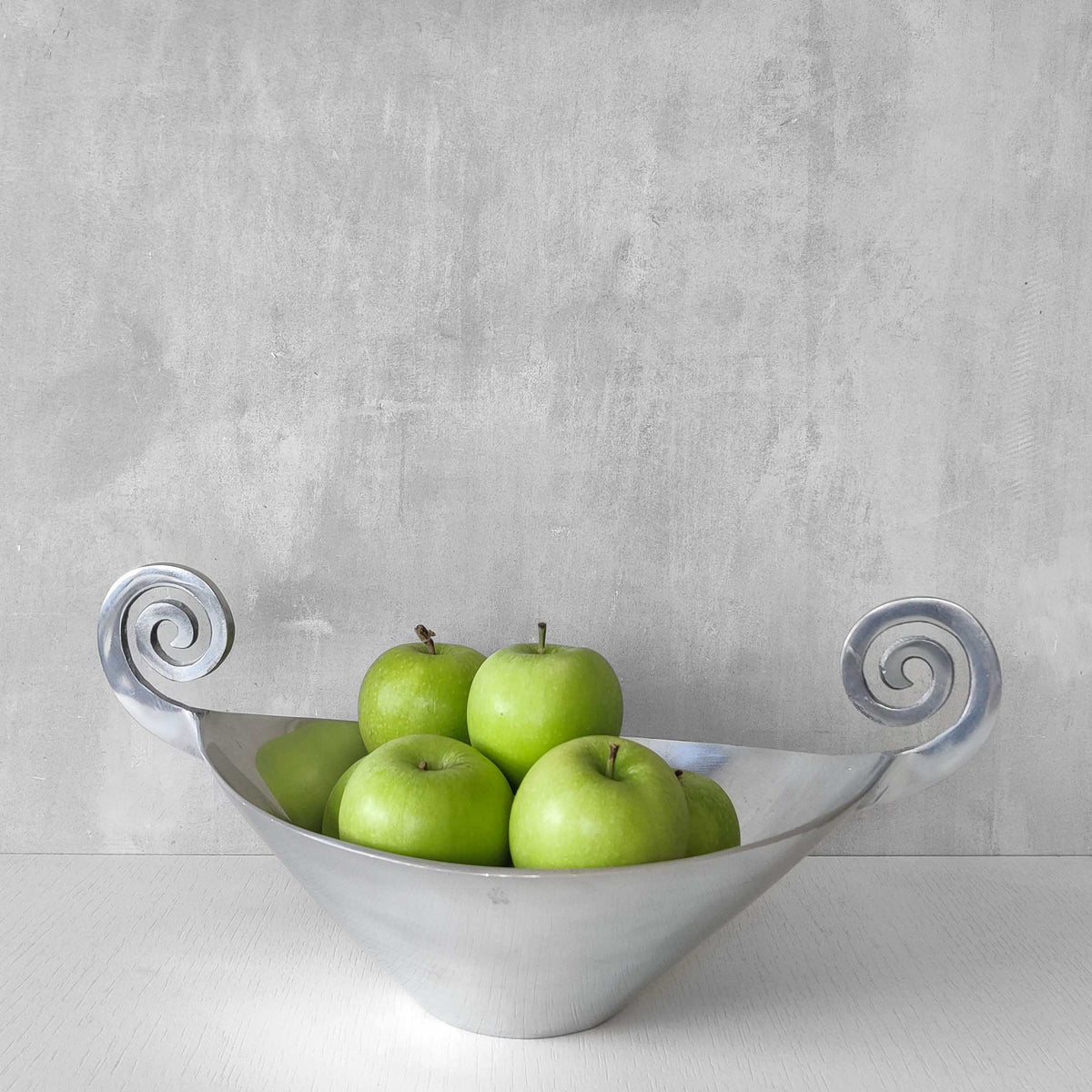 A 1990s cast aluminium centrepiece bowl with spiral handles