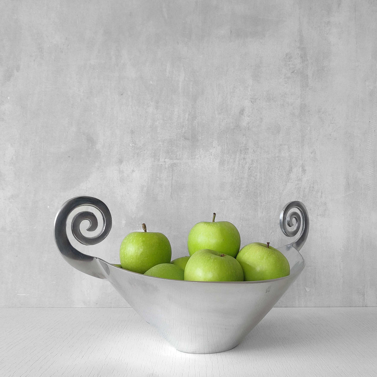 A 1990s cast aluminium centrepiece bowl with spiral handles